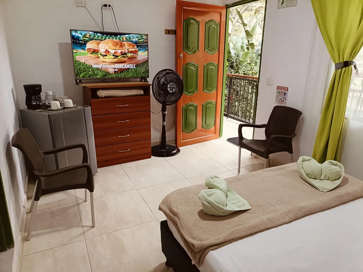 Nirvana 3: habitación con TV, nevera y puerta al balcón